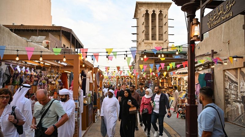 Visitors at a Dubai souq. The tourism sector's 'robust recovery' should help government-related entities to repay debt, said S&P