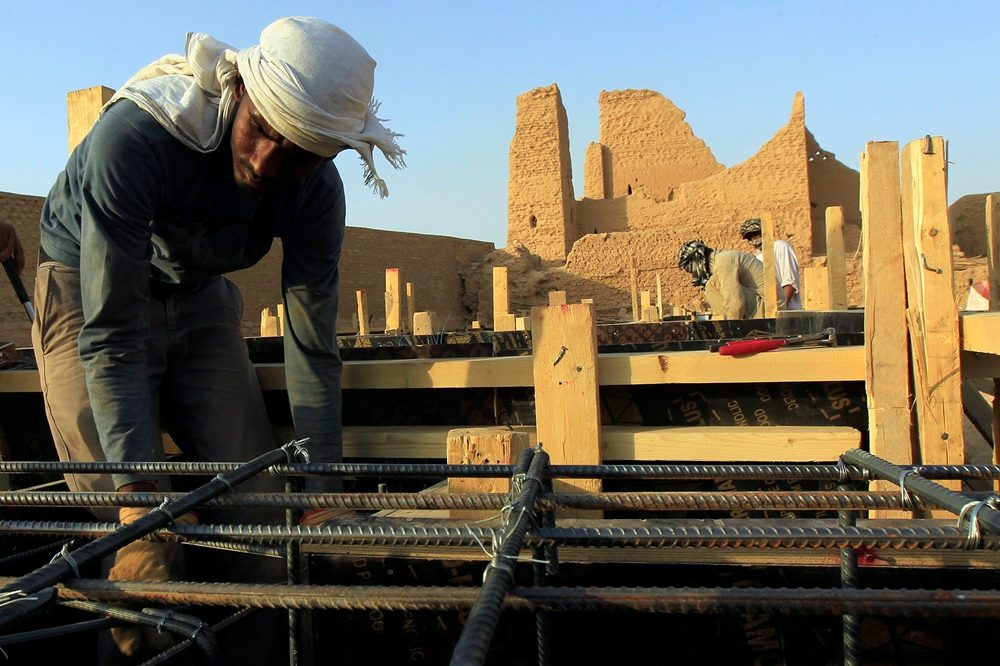 A worker restoring the Diriyah district, one of the giga-projects Saudi Arabia is using a budget deficit to create