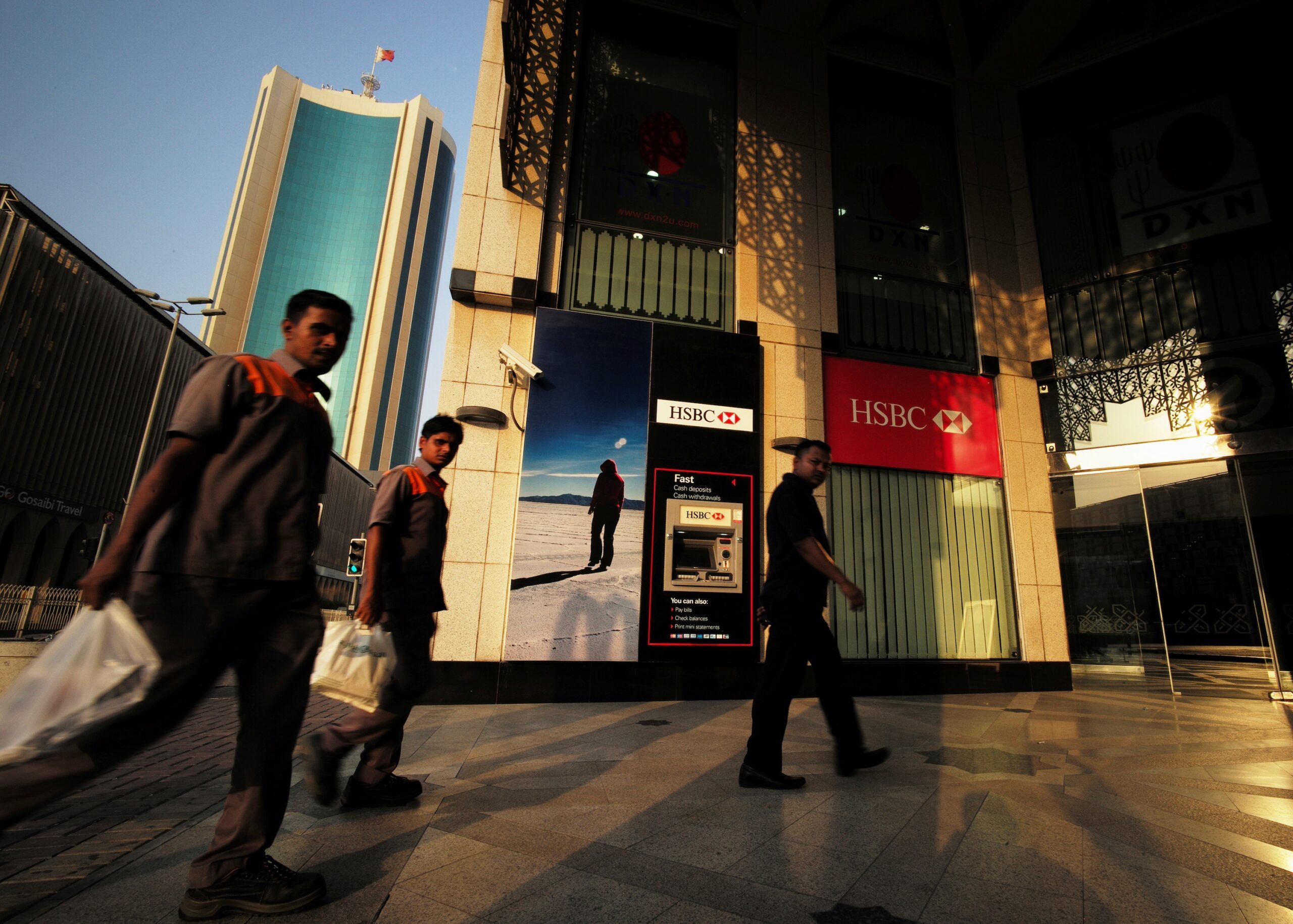 Men walk past an HSBC branch in Manama. HSBC Bank Middle East made pre-tax profit of $1.2bn in 2023