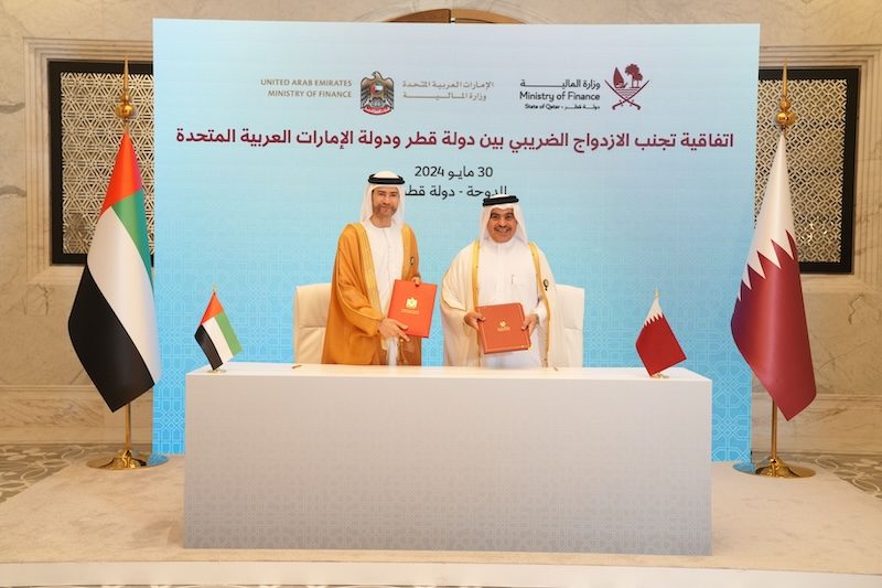 Mohamed Hadi Al Hussaini, UAE minister of state for financial affairs, and Qatari finance minister Ahmed Al Kuwari sign the tax agreement