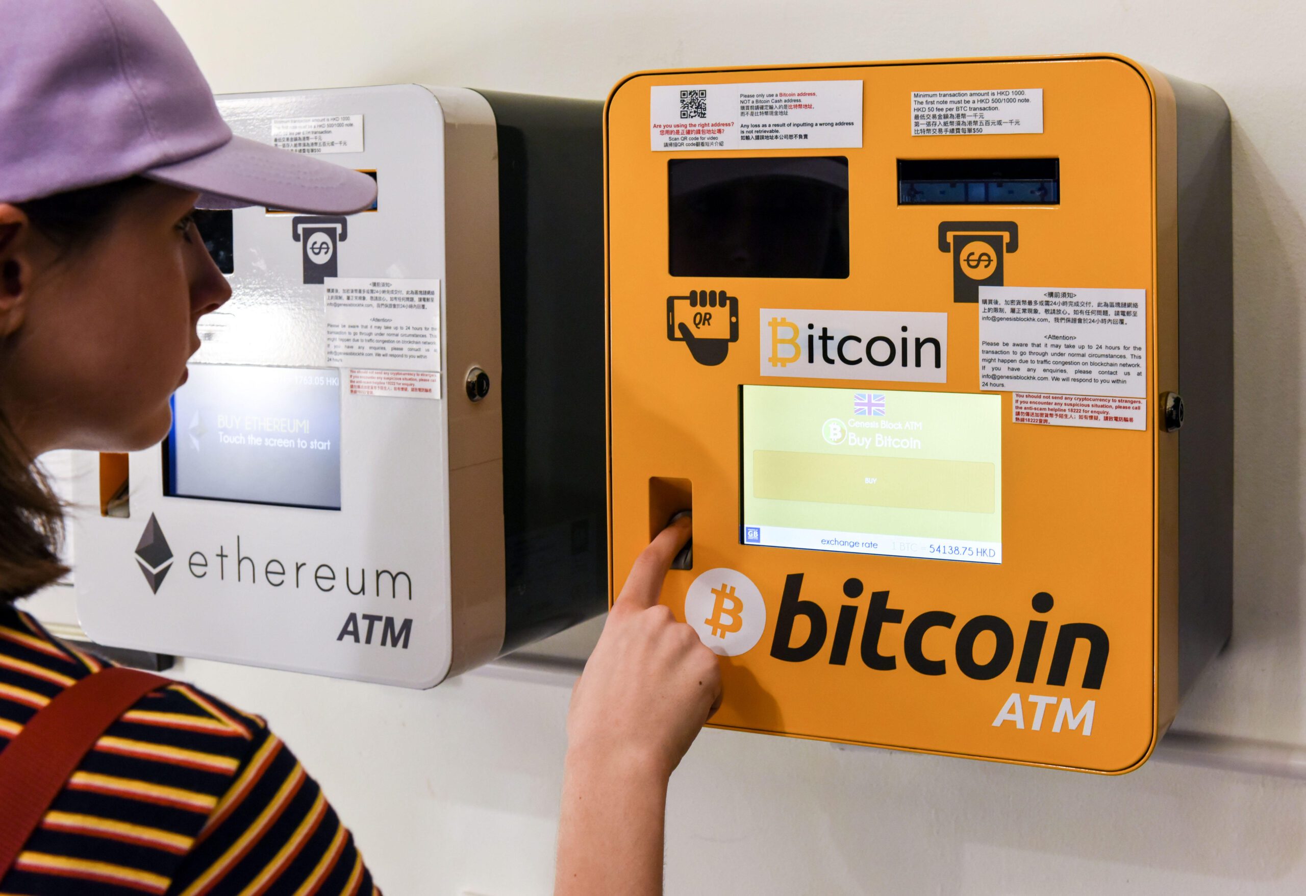 A woman using a Bitcoin ATM in Hong Kong. The Mena region accounts for 7% of global cryptocurrency volumes