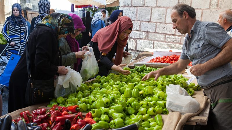 Shoppers choose vegetables in Istanbul; inflation means people are spending on essentials