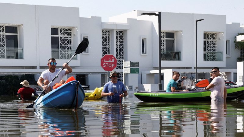Residents use kayaks to evacuate their flooded residential complex in Dubai following the April storm
