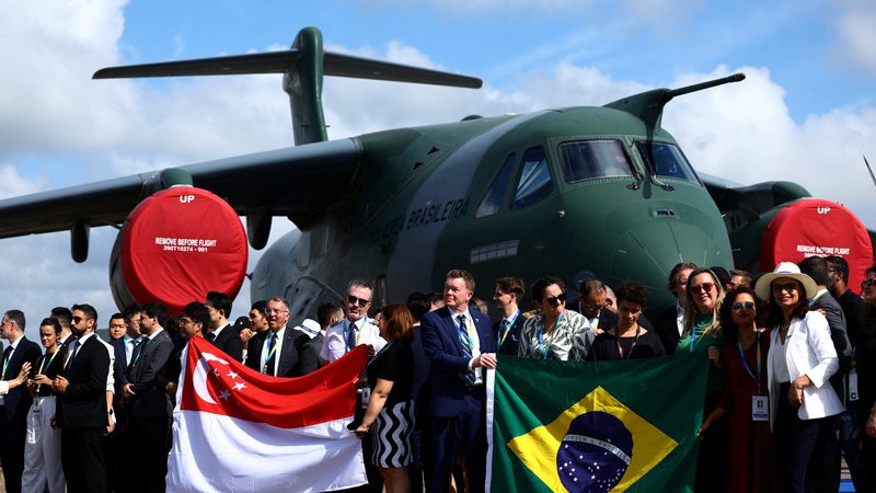 A Brazilian delegation in front of an Embraer C-390 aircraft at the Singapore Airshow in February