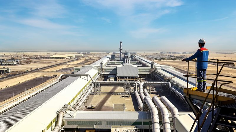An EGA employee looks out over its Al Taweelah facility in Abu Dhabi. The electricity used in aluminium smelting makes up 60% of its carbon footprint