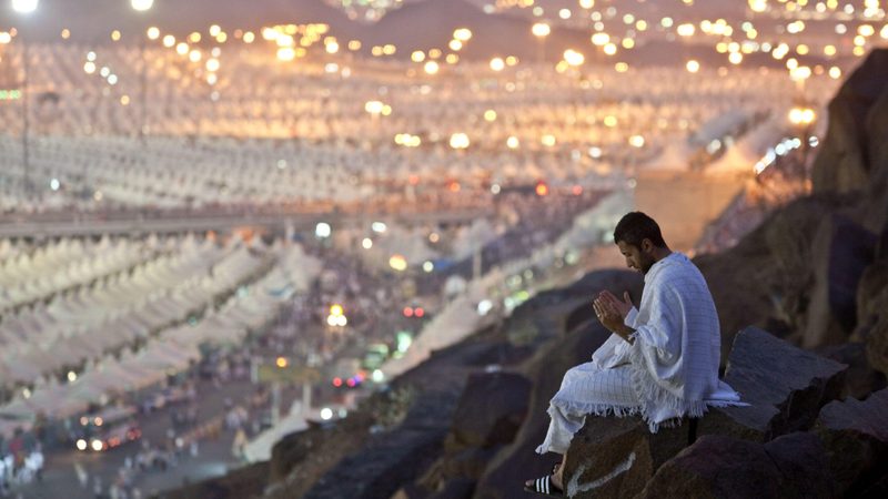 A pilgrim prays on Mount Arafat, Mecca. Saudi Arabia has been enforcing a strict crackdown on performing Hajj without a permit