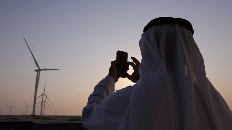 A visitor marks the occasion of the inauguration of Masdar's wind farm on Sir Bani Yas Island, in Abu Dhabi
