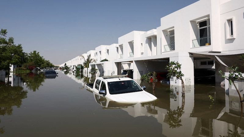 Cars lie partially submerged at a residential complex following heavy rainfall in Dubai in April
