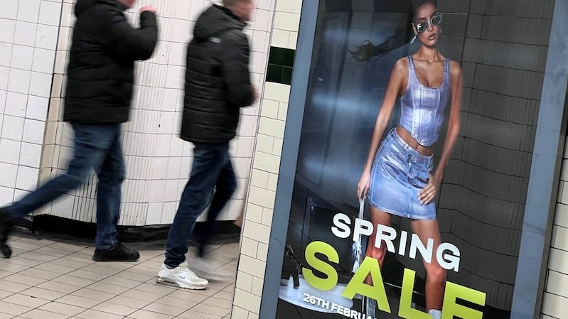 People walk past an advertisement for Shein in London. The company says it is investing in textile recycling startups in the UK