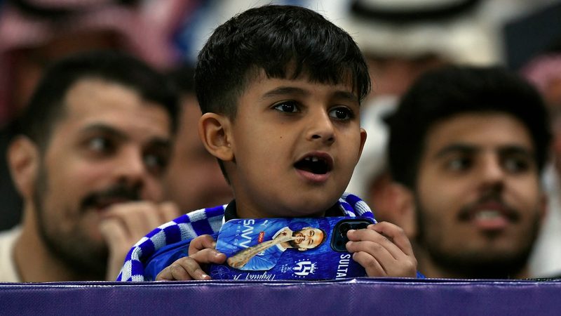A young Al Hilal fan (with Neymar phone case) watches his side play Al Ittihad at the Kingdom Arena in Riyadh. Fewer superstar signings are expected this summer