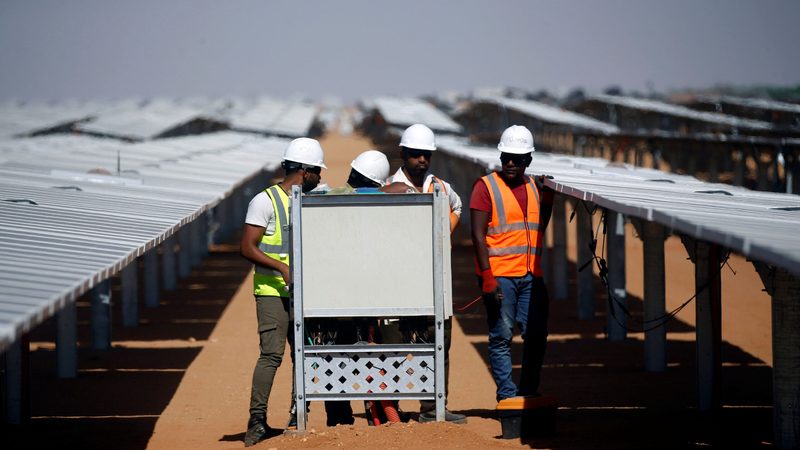 Workers set up photovoltaic solar panels at the Benban plant, which will contribute to Egypt's goal of 58 percent renewable energy by 2040