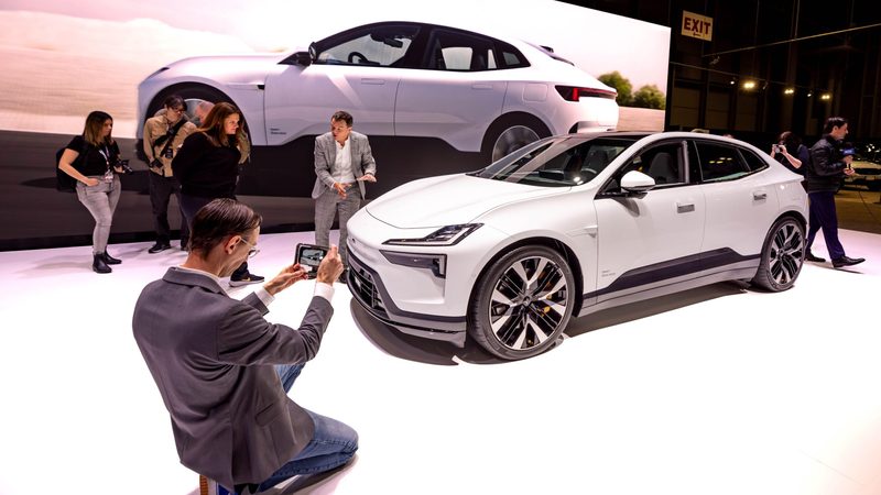 Visitors at the New York International Auto Show look at a Polestar 4 electric SUV. But will it survive the ICE age?