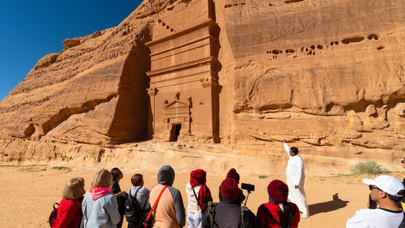 Tourists visit the Nabatean tombs in AlUla. The ministry of tourism said more than 106 million tourists visited Saudi Arabia last year