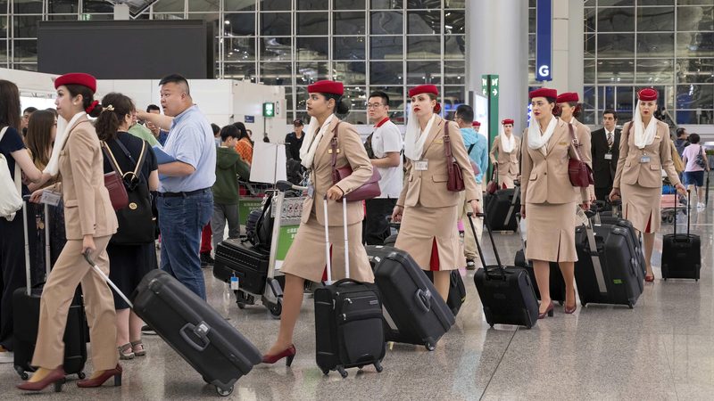 Airport, Clothing, Footwear 2X9TYG8 Hong Kong, China. 4th May, 2024. Female Emirates airline flight crew and staff arrive at the departure check-in desks at Chek Lap Kok International Airport in Hong Kong. (Credit Image: © Budrul Chukrut/SOPA Images via ZUMA Press Wire) EDITORIAL USAGE ONLY! Not for Commercial USAGE!