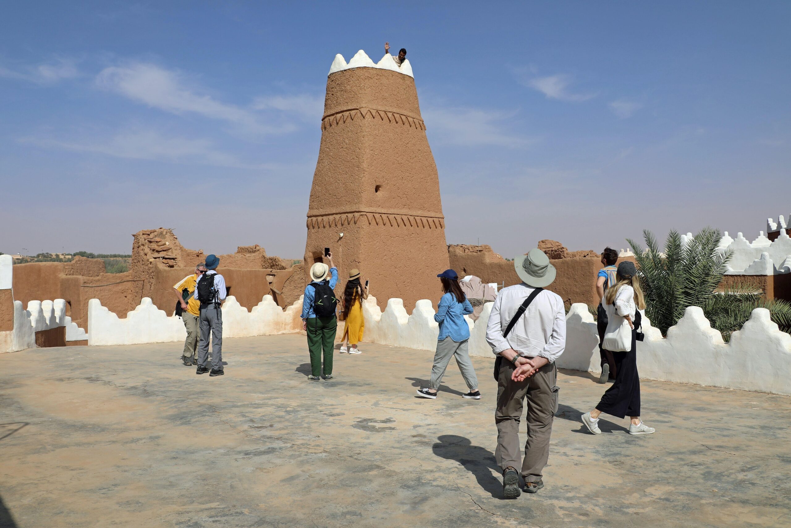 Tourists visiting Ushaiqer Heritage Village in Saudi Arabia. The government says 104 million tourists visited the country in 2023