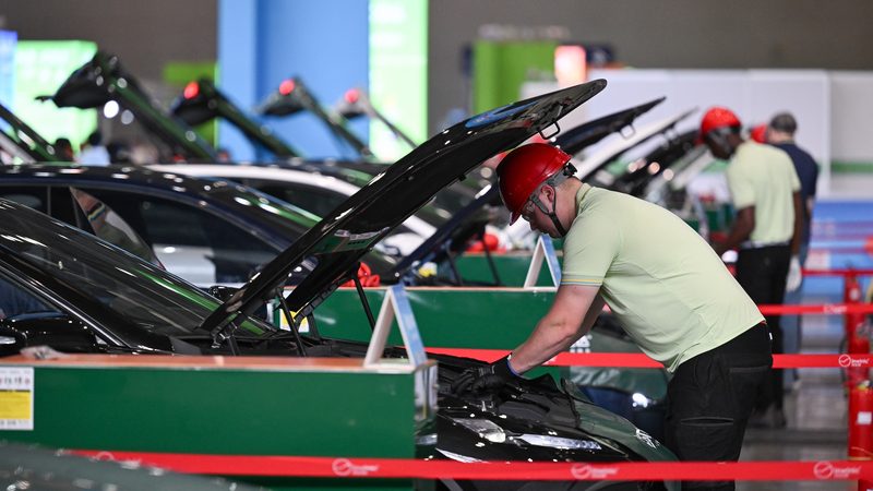 CHONGQING, CHINA - JUNE 25: A participant shows his new energy vehicle maintenance skills during a contest of the second Belt and Road International Skills Competition at Chongqing International Expo Center on June 25, 2024 in Chongqing, China. (Photo by He Penglei/China News Service/VCG )No Use China