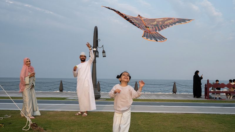 A familly plays with a kite at the Mina district (Old Doha Port) in Doha, Qatar, January 31, 2024. REUTERS/Marko Djurica A family enjoys playing with a kite in Doha. Analysts say that expansion of the North Field will boost Qatar's economy