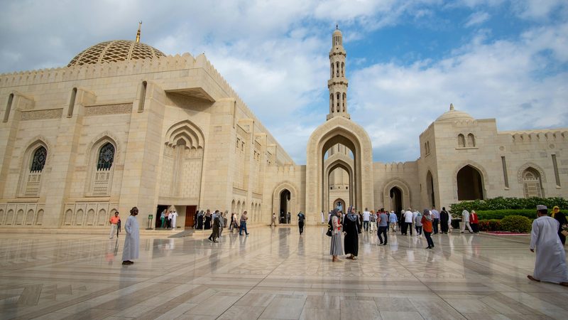 Visitors outside Sultan Qaboos Mosque in Muscat; the labour law revision will affect expatriate employment in sectors including oil and gas, real estate and tourism