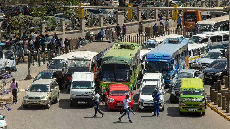 Pedestrians share the road with traffic in Nairobi; Kenya has been struggling to manage its debt load