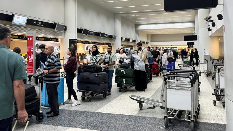 Passengers queue at Beirut-Rafic Al Hariri International Airport. Many airlines have suspended operations to Tel Aviv and Beirut