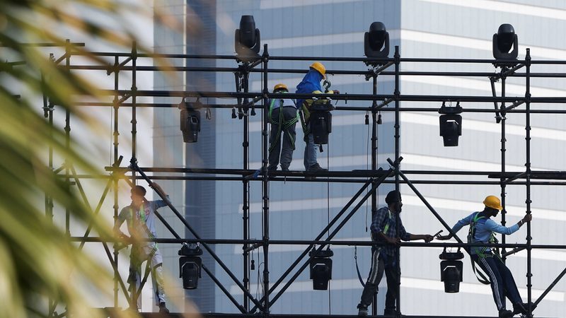 Workers stand on a scaffold in Dubai. Building a high rise in the UAE can be as much as two thirds cheaper than in other major cities