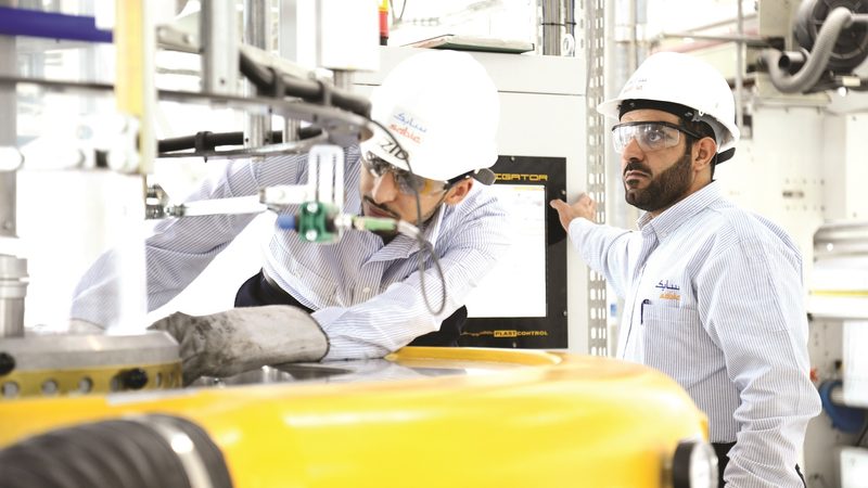 Employees at Sabic's Jubail manufacturing site; increased prices for products helped raise profits