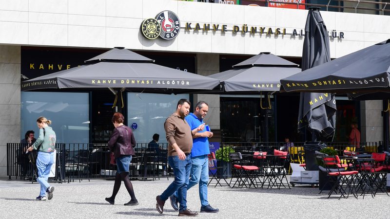 Shoppers walk past a coffee shop at a shopping mall in Ankara, Turkey