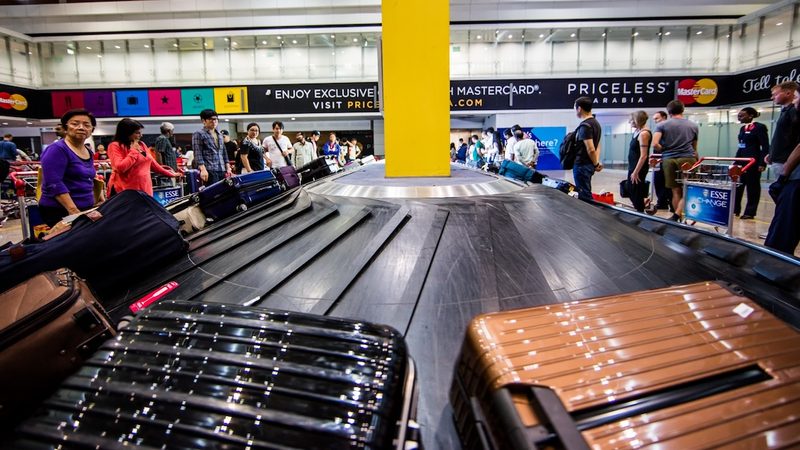 Passengers collect their luggage at terminal 1 in Dubai International airport. DXB expects to handle 91.9m passengers this year