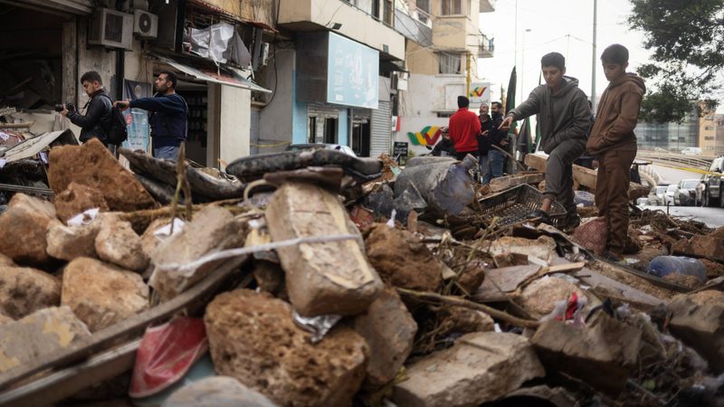 People look at the aftermath of an Israeli strike in Beirut, Lebanon. Rebuilding costs could reach an estimated $25bn