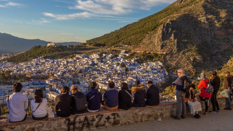 Tourists enjoying the view of Chefchaouen from the Spanish Mosque, northwest Morocco