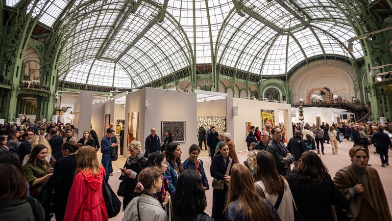 People attend the Art Basel art fair at the Grand Palais in Paris in October. A rumoured $20m investment would underpin the partnership with Abu Dhabi Art Fair