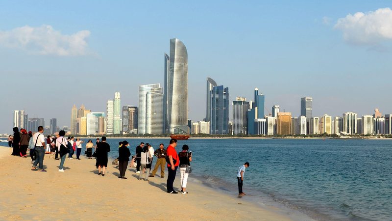 Tourists view the Abu Dhabi skyline. Most visitors come from India, China, Russia, the UK and Saudi Arabia