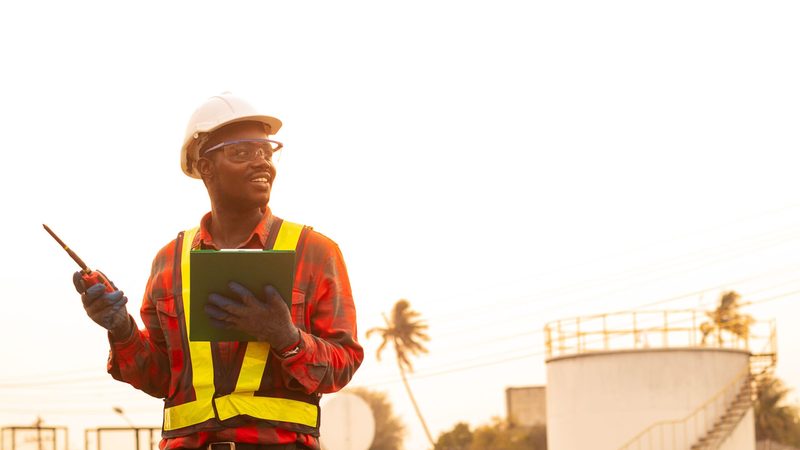 African man engineer use radio communication working at oil industrial