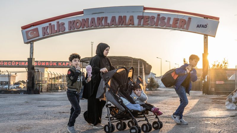 A Syrian family crosses into Syria from Turkey at the Oncupinar border crossing near the town of Kilis in southern Turkey. Syrian refugees in Turkey started their journey back home following the collapse of the regime of Bashar al-Assad