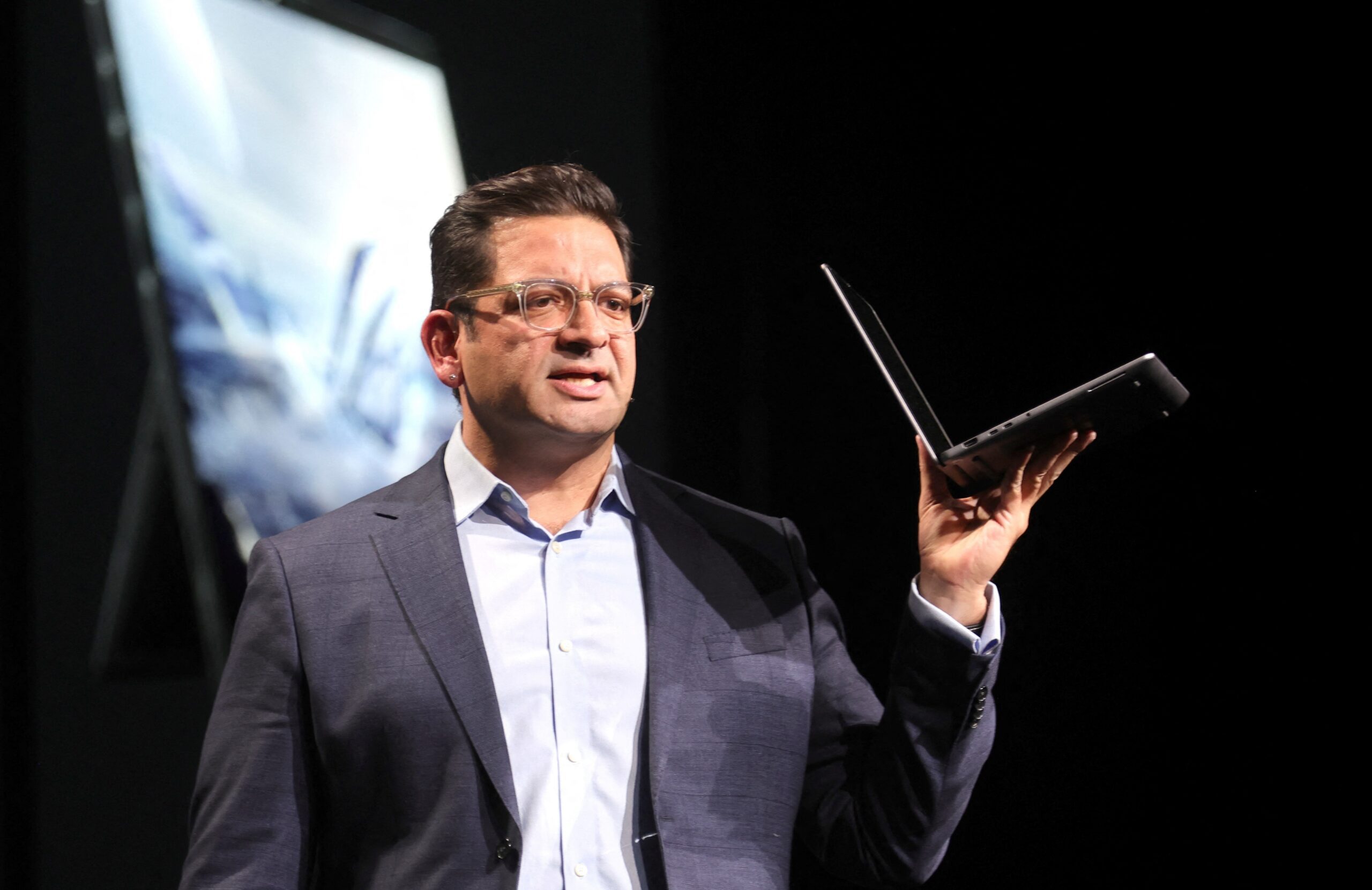 Rahul Tikoo, vice president at chip designer AMD, holds HP's AI-capable Zbook Ultra G1a laptop at CES 2025 in Las Vegas