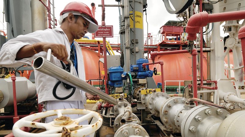 Workers preparing for loading crude oil form ship to taker in Chonburi, Thailand