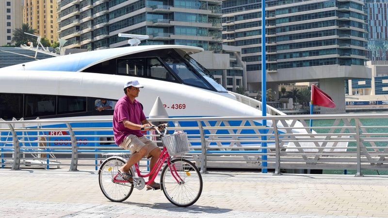 A tourist man riding a bicycle inside the city