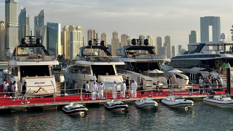 Visitors inspect yachts at Dubai's International Boat Show. The city's economic stability and climate are major draws for the super-rich