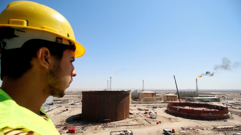 An Iraqi worker looks at the Shuaiba oil refinery in southwest Basra; Iraq is on a drive expand and update its refineries to meet a steady rise in demand