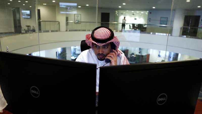 A trader checks the market at the Saudi exchange; Derayah Derayah is considering seeking a valuation of about $2 billion