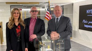 IonQ staff (CEO Peter Chapman on the right) at a display of the company's Ion Trap technology at the New York Stock Exchange last month