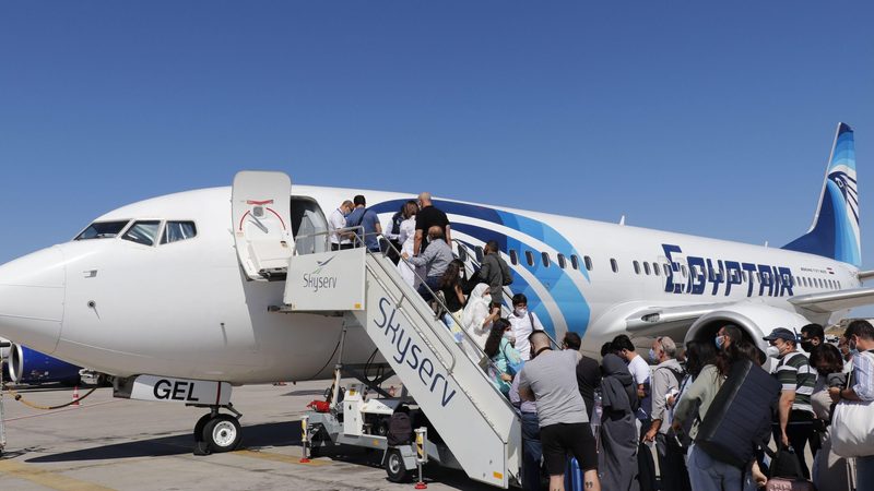 People board an Egyptair flight at Cairo airport. Egypt's new airport, Sphinx International, will play a vital role in expanding the aviation sector