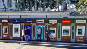 Customers use cash dispensers in Istanbul. The Institute of International Finance says 'many emerging markets have experienced a marked deterioration in their debt-carrying capacity'