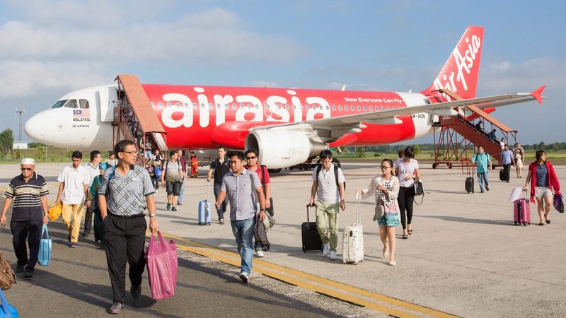 Passengers disembarking from an AirAsia Airbus A320 at Kuala Lumpur, Malaysia. The airline has a $225m fundraising target