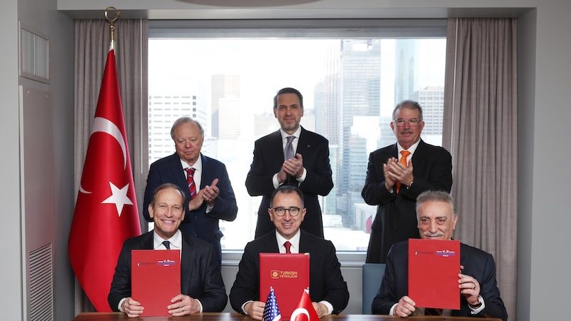 Oil company executives sign the oil and gas deal in the presence of Turkish energy minister Alparslan Bayraktar (centre standing)