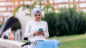 A woman uses her smartphone. Analysts say the real challenge for Gulf telecoms operators is not 6G, but getting more from 5G