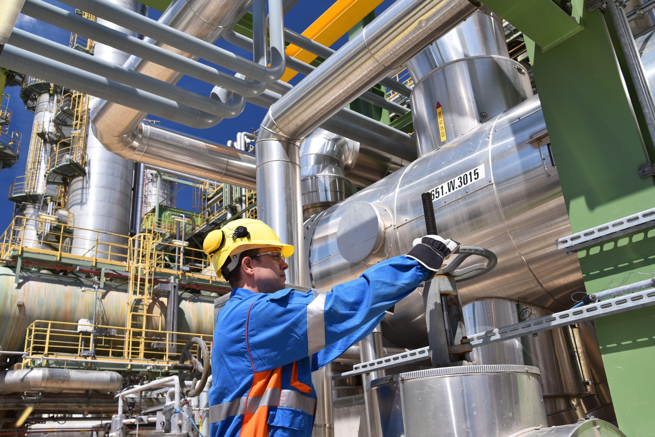 workers in an industrial plant for the production and processing of crude oil