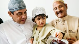 Two men and a child eating dates. Many Muslims turn to dates to break their fast during Ramadan but prices in Turkey have risen