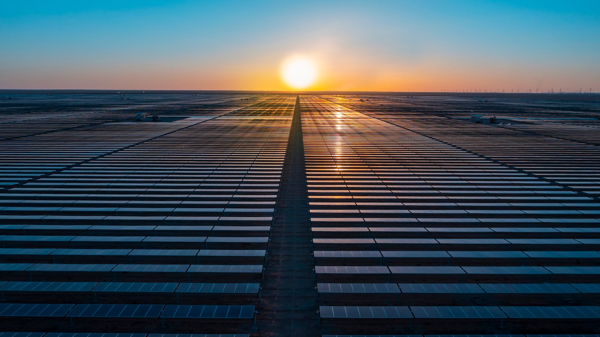 The sun is low in the sky over panels at the Sakaka Solar Power Plant in Saudi Arabia