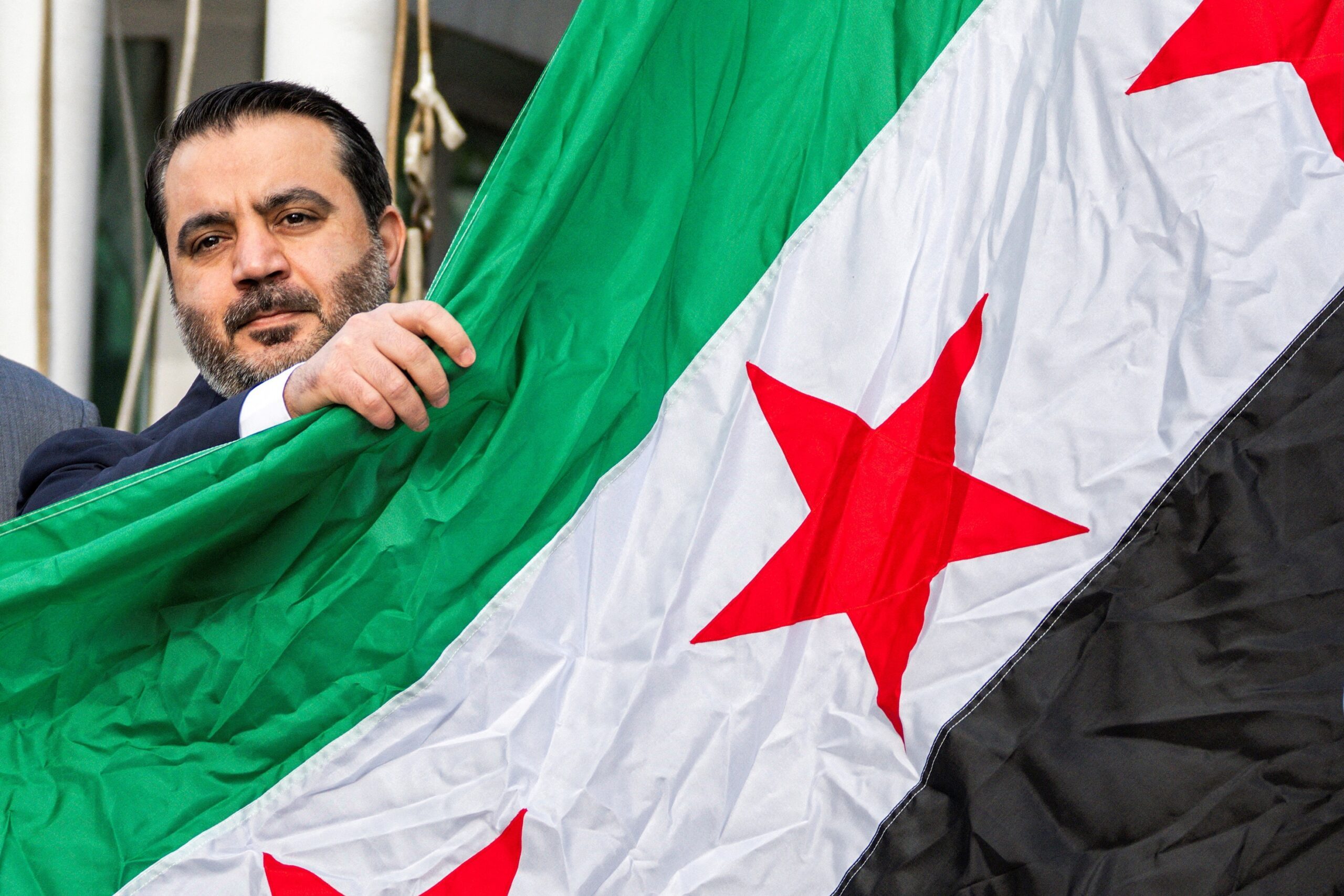 Syrian Foreign Minister Asaad Hassan al-Shibani at the raising of the new Syrian flag at the UN in New York